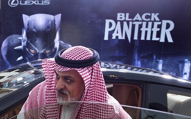 A visitor checks out a Lexus car, similar to a one used in the Black Panther film, that is on display outside an invitation-only screening, at the King Abdullah Financial District Theater, in Riyadh, Saudi Arabia, April 18, 2018. (AP Photo/Amr Nabil)