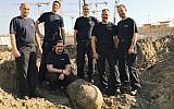 Photo provided by Berlin police Friday, April 20, 2018 shows the bomb squad of the state police Berlin posing behind a bomb from WWII that was found in central Berlin and is planned to be defused on Friday. (Polizei Berlin via AP)