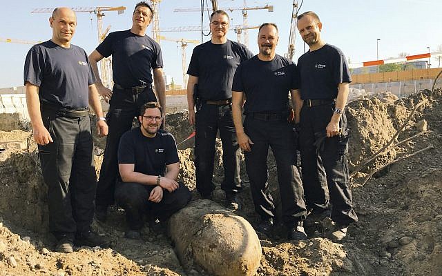 Photo provided by Berlin police Friday, April 20, 2018 shows the bomb squad of the state police Berlin posing behind a bomb from WWII that was found in central Berlin and is planned to be defused on Friday. (Polizei Berlin via AP) Photo provided by Berlin police Friday, April 20, 2018 shows the bomb squad of the state police Berlin posing behind a bomb from WWII that was found in central Berlin and is planned to be defused on Friday. (Polizei Berlin via AP)