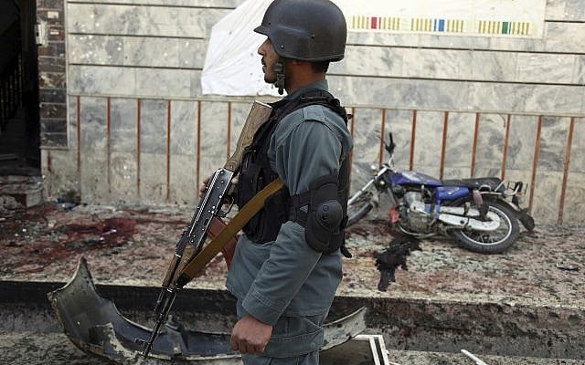 An Afghan police officer stands outside a voter registration center which was attacked by a suicide bomber in Kabul, Afghanistan, Sunday, April 22, 2018. (AP Photo/Rahmat Gul) An Afghan police officer stands outside a voter registration center which was attacked by a suicide bomber in Kabul, Afghanistan, Sunday, April 22, 2018. (AP Photo/Rahmat Gul)