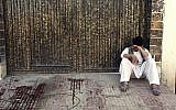 A relative of a victim cries outside a voter registration center which was attacked by a suicide bomber in Kabul, Afghanistan, Sunday, April 22, 2018. (AP Photo/ Rahmat Gul)