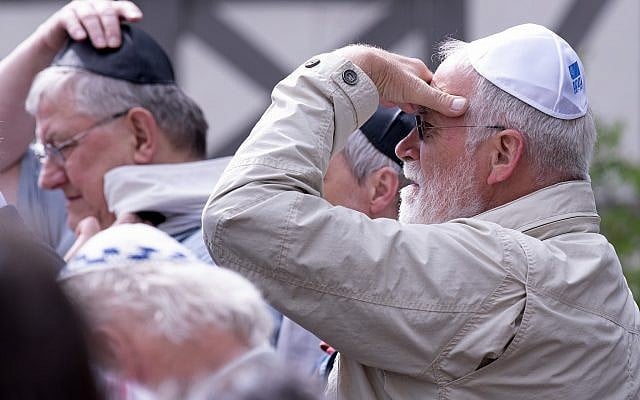 People of different faiths wear the Jewish kippa during a demonstration against antisemitism in Germany in Erfurt, Germany, April 25, 2018. (AP Photo/Jens Meyer)