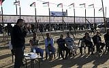 In this Monday, April 23, 2018 photo, trainer Tareq Isleem teaches Palestinian youths participating in a workshop about 'non-violent' resistance and 'peaceful' protests at a tent near the protest site near Gaza's border with Israel, east of Gaza City. (AP Photo/Adel Hana)