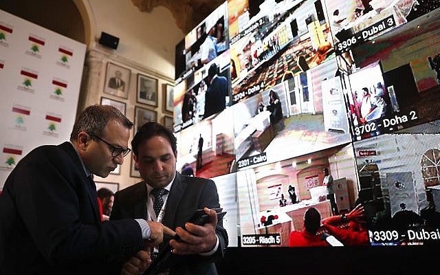 Lebanese Foreign Minister Gibran Bassil, left, talks with an assistant as they stand next to a giant screen following voting by Lebanese expatriates in six Arab countries, ahead of parliamentary elections scheduled to be held in Lebanon on May 6, at the Lebanese Foreign Ministry in Beirut, on April 27, 2018. (AP Photo/Hussein Malla) Lebanese Foreign Minister Gibran Bassil, left, talks with an assistant as they stand next to a giant screen following voting by Lebanese expatriates in six Arab countries, ahead of parliamentary elections scheduled to be held in Lebanon on May 6, at the Lebanese Foreign Ministry in Beirut, on April 27, 2018. (AP Photo/Hussein Malla)