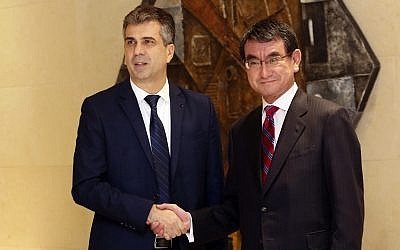 Economy Minister Eli Cohen, left, shakes hands with Japan's Foreign Minister Taro Kono before a meeting on the "Corridor for Peace and Prosperity," at Dead Sea, Jordan, April 29, 2018. (AP Photo/Raad Adayleh)