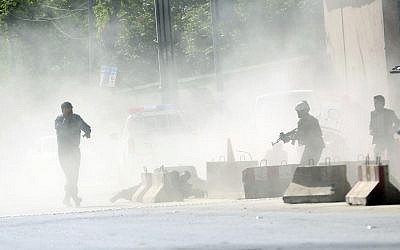 Security forces run from the site of a suicide attack after the second bombing in Kabul, Afghanistan, April 30, 2018. (AP Photo/Massoud Hossaini)