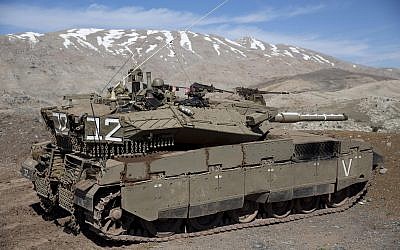 File: Israeli soldiers peer into Syria from their tank on the Golan Heights on February 18, 2016. (Ariel Schalit/AP Photo)