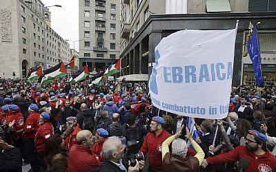 People hold up a flag of the Jewish Brigade as Palestinian flags wave in background during a demonstration to mark Italy's Liberation day, in Milan, Italy, April 25, 2017. (AP Photo/Luca Bruno)