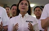 Philippine Vice President Leni Robredo attends a mass wearing a sticker "Never Again" at the University of the Philippines Church of the Holy Sacrifice to commemorate the 45th anniversary of the imposition of martial law by the late Philippine dictator Ferdinand Marcos in metropolitan Manila, Philippines, September 21, 2017. (AP Photo/Aaron Favila)