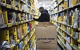 Illustrative: In this Wednesday, Dec. 20, 2017, photo, a clerk picks an item from a shelf and scans it with a hand-held device to fill a customer order at the Amazon Prime warehouse in New York. (AP)