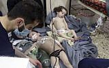 Medical workers treating toddlers following an alleged poison gas attack in the opposition-held town of Douma, in Eastern Ghouta, near Damascus, Syria, April. 8, 2018 (Syrian Civil Defense White Helmets via AP)