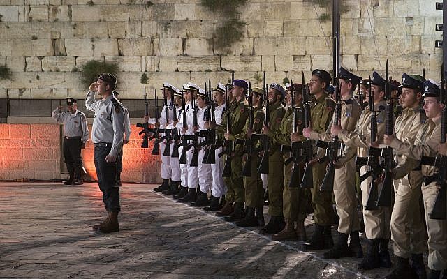 Israeli soldiers stand in formation during a ceremony to mark the annual Memorial Day for Israel's fallen soldiers and terror victims at the Western Wall, the holiest site where Jews can pray, Tuesday, April 17, 2018. (AP Photo/Sebastian Scheiner)