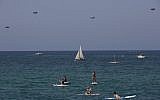 Paratroopers drop into the Mediterranean Sea during Independence Day celebrations marking 70 years since the founding of the state in 1948, in Tel Aviv, Israel, Thursday, April 19, 2018. (AP Photo/Oded Balilty)