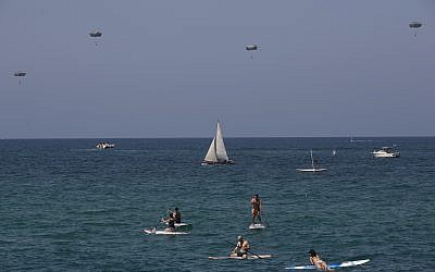Paratroopers drop into the Mediterranean Sea during Independence Day celebrations marking 70 years since the founding of the state in 1948, in Tel Aviv, Israel, Thursday, April 19, 2018. (AP Photo/Oded Balilty)