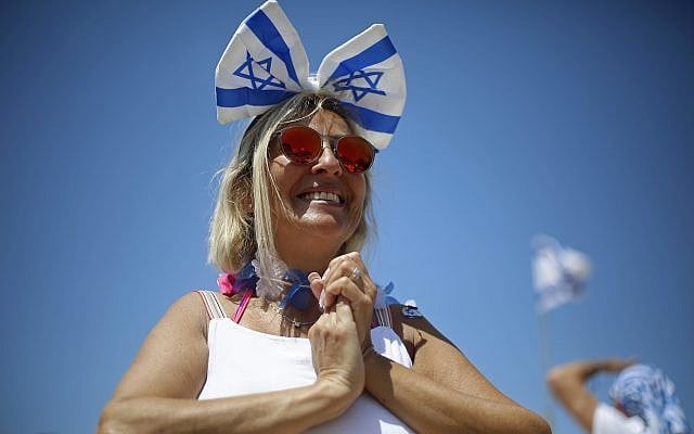 A woman smiles during Independence Day celebrations marking 70 years since the founding of the state in 1948, in Tel Aviv, Israel, Thursday, April 19, 2018. (AP Photo/Ariel Schalit)