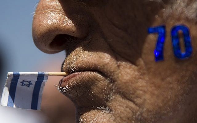 An Israeli man celebrates Independence Day marking 70 years since the founding of the state in 1948, in Tel Aviv, Israel, Thursday, April 19, 2018. (AP Photo/Oded Balilty)
