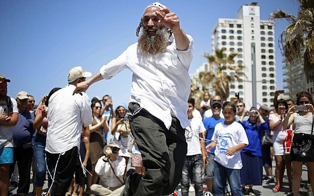 People dance during Independence Day celebrations marking 70 years since the founding of the state in 1948, in Tel Aviv, Israel, Thursday, April 19, 2018. (AP Photo/Ariel Schalit)