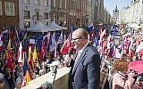 The mayor of Gdansk, Pawel Adamowicz,center, addresses a rally he organized in protest against a recent gathering by far-right groups in this Baltic coast city, in Gdansk, Poland, on Saturday, April 21, 2018. (AP Photo/Wojciech Strozyk)