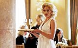 This image released by Bravo shows Inbar Lavi in a scene from "Imposters," where she plays a con artist who tricks men and women into marrying her and then steals all their money. (Ken Woroner/Bravo via AP)