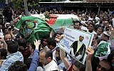 The coffin of Palestinian Fadi al-Batsh is carried out of a mosque after a prayer in Selayang, on the outskirt of Kuala Lumpur, Malaysia, April 25, 2018 (AP Photo/Vincent Thian)