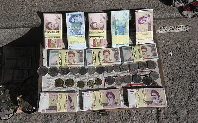 Illustrative photo of Iranian banknotes and foreign coins displayed by a vendor on a side walk of the Ferdowsi Street in Tehran, Iran, January 23, 2013. (Vahid Salemi/AP) Illustrative photo of Iranian banknotes and foreign coins displayed by a vendor on a side walk of the Ferdowsi Street in Tehran, Iran, January 23, 2013. (Vahid Salemi/AP)