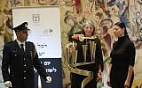 Suzi Kastner (C) lights a memorial candle in the Knesset for her father, Israel Rudolf Kastner at the parliament's official Holocaust Remembrance Day ceremony. Her daughter, Zionist Union MK Merav Michaeli, is pictured on the right (Knesset spokesperson's office/Yonatan Sindel)