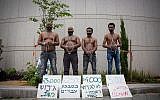 African asylum seekers set up a mock slave auction as part of a protest against their deportation outside the Ministry of Defense in Tel Aviv, on  April 3, 2018. (Miriam Alster/Flash90)