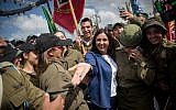 Culture and Sports Minister Miri Regev poses for photographs with Israeli soldiers on April 9, 2018, as she arrives at a press conference at Mt Herzl in Jerusalem, where the official national celebrations will be held in honor of Israel's 70th Independence Day next week. (Yonatan Sindel/Flash90)