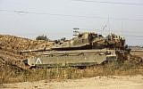 An IDF tank is seen near the border with Gaza on April 13, 2018 (Sliman Khader/Flash90)