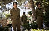 Illustrative image of Israeli soldiers placing Israeli flags on the graves of fallen soldiers in Mount Herzl Military Cemetery in Jerusalem, on April 16, 2018. (Hadas Parush/Flash90)