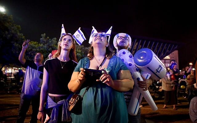 People watch fireworks during a show to mark Israel's 70th Independence Day in Tel Aviv on April 18, 2018. (Miriam Alster/Flash90) People watch fireworks during a show to mark Israel's 70th Independence Day in Tel Aviv on April 18, 2018. (Miriam Alster/Flash90)