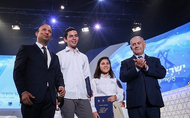 Education Minister Naftali Bennett (L), Azriel Shilat (2nd-L), Oriah Cohen (2nd-R) and Prime Minister Benjamin Netanyahu (R) at the International Bible Quiz, which is held annually on Independence Day, in Jerusalem, on April 19, 2018. Shilat was the winner of the contest and Cohen was the runner-up. (Shlomi Cohen/Flash90) Education Minister Naftali Bennett (L), Azriel Shilat (2nd-L), Oriah Cohen (2nd-R) and Prime Minister Benjamin Netanyahu (R) at the International Bible Quiz, which is held annually on Independence Day, in Jerusalem, on April 19, 2018. Shilat was the winner of the contest and Cohen was the runner-up. (Shlomi Cohen/Flash90)