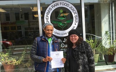 Maharat Ruth Friedman with the manager of Khepra’s Raw Food Juice Bar, a vegan restaurant she and Rabbi Shmuel Herzfeld recently certified kosher. (Courtesy of Friedman/via JTA)