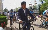 Prime Minister Benjamin Netanyahu wears a helmet while riding a bicycle in a video released on April 25, 2018, ahead of the Giro D’Italia cycle race to be held in Israel in May. (Screen capture: Twitter video)