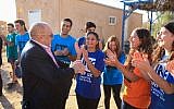 Samuel Hayek, in jacket, meeting young musicians in Ashdod in January 2018. (Jewish National Fund-United Kingdom/via JTA)