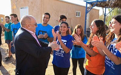 Samuel Hayek, in jacket, meeting young musicians in Ashdod in January 2018. (Jewish National Fund-United Kingdom/via JTA)