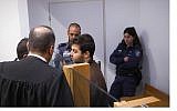 Screen capture from video of Kamel Abu Amarah, center, an Arab Israeli accused of joining the Islamic State group, seen in Tel Aviv District Court, April 18, 2018. (Screen capture: Walla news)