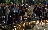 Israeli teens light candles at a vigil at Tel Aviv's Rabin Square on April 28, 2018, in memory of the 10 victims killed in a flash flood while hiking in the Judean Desert. (Screen capture/YouTube)
