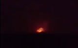 An explosion is seen coming from an army base, allegedly used by Iran-backed militias, outside the northern Syria city of Hama on April 29, 2018. (Screen capture; Facebook)