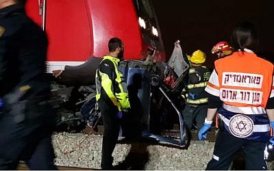 Medics at the scene of a collision between a train and a car in central Israel, April 7, 2018 (MDA)
