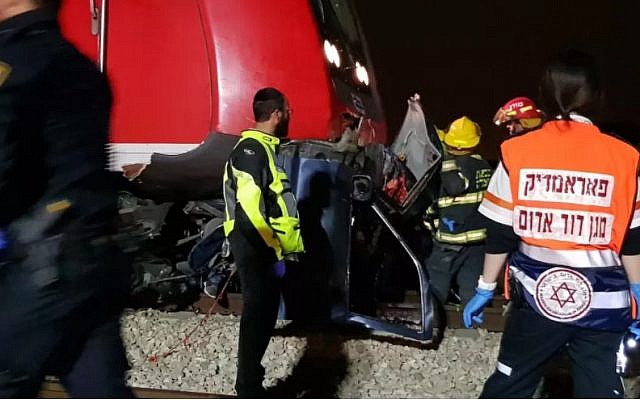 Medics at the scene of a collision between a train and a car in central Israel, April 7, 2018 (MDA)
