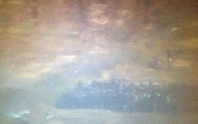 Palestinians are seen approaching the border fence between Israel and the Gaza Strip during what the IDF called an attempted mass breach of the border, on April 27, 2018. (IDF spokesperson)