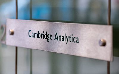 Signs for the company Cambridge Analytica in the lobby of the London, UK, building in which it is based, March 21, 2018. (Chris J Ratcliffe/Getty Images via JTA)