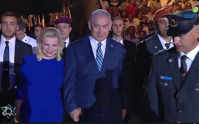 Prime Minister Benjamin Netanyahu (R) and his wife Sara arrive at the torch lighting ceremony at Mount Herzl on April 18, 2018. (Screen capture/Facebook) Prime Minister Benjamin Netanyahu (R) and his wife Sara arrive at the torch lighting ceremony at Mount Herzl on April 18, 2018. (Screen capture/Facebook)