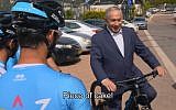 Prime Minister Benjamin Netanyahu hops on a bicycle in a video released on April 25, 2018, ahead of the Giro D’Italia cycle race to be held in Israel in May. (Screen capture: Twitter video)