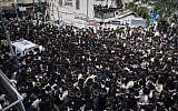 Ultra-Orthodox Jewish men gather at Kikar Shabbat in Jerusalem to attend the funeral of the infant who drowned to death in Ashdod,  April 5, 2018. (Noam Revkin Fenton/Flash90)