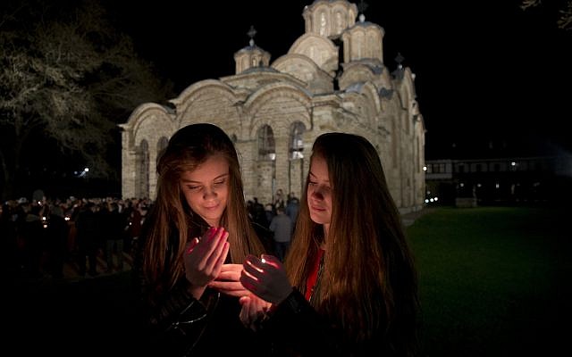 Kosovo Serb Orthodox pilgrims hold candles during an Easter vigil mass in the monastery of Gracanica during an Easter service, Kosovo, April 8, 2018. (AP Photo/Visar Kryeziu)