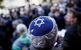 Illustrative: A participant wears a kippah during a 'wear a kippah' gathering to protest against anti-Semitism in front of the Jewish Community House on April 25, 2018 in Berlin, Germany. (Carsten Koall/Getty Images via JTA)