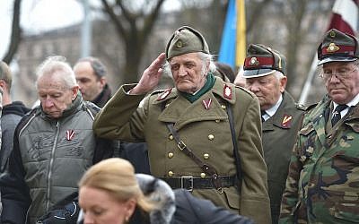 A man dressed in a pre-WWII Latvian military uniform salutes as veterans of the Latvian Legion, a force that was commanded by the German Nazi Waffen SS during WWII, and their sympathizers walk to the Monument of Freedom in Riga, Latvia on March 16, 2016. (Ilmars Znotins/AFP/Getty Images/via JTA) A man dressed in a pre-WWII Latvian military uniform salutes as veterans of the Latvian Legion, a force that was commanded by the German Nazi Waffen SS during WWII, and their sympathizers walk to the Monument of Freedom in Riga, Latvia on March 16, 2016. (Ilmars Znotins/AFP/Getty Images/via JTA)