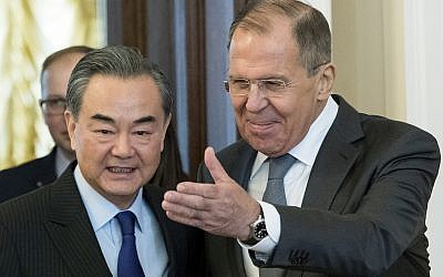 Russian Foreign Minister Sergey Lavrov, right, and China's Foreign Minister Wang Yi enter a hall during their meeting in Moscow, Russia, April 5, 2018. (AP Photo/Pavel Golovkin)